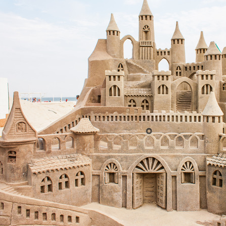 Grand sandcastle on the beach during a summer day